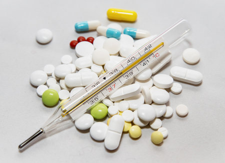 Bunch of drugs and thermometer.