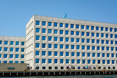 COPENHAGEN, DENMARK - JUNE 25 2016: People are walking in front of an office building located on the water front in Copenhagen.のeditorial素材