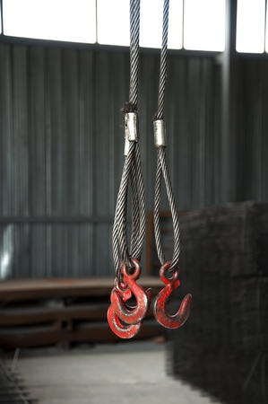Three metal hooks with wire rope. Reinforcing steel backgroundの写真素材