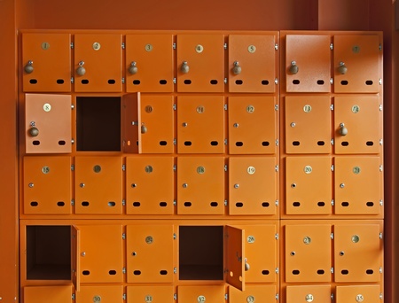 Many orange mailboxes. Some of them openedの写真素材