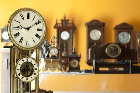 Old antique clocks close up and blurred background clocksの写真素材