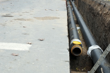 Installing pipes for hot water and steam heating. City heat pipelineのeditorial素材