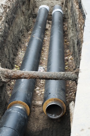 Installing pipes for hot water and steam heating. City heat pipelineのeditorial素材