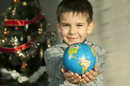 Child who give as gift the world on Christmas.の写真素材