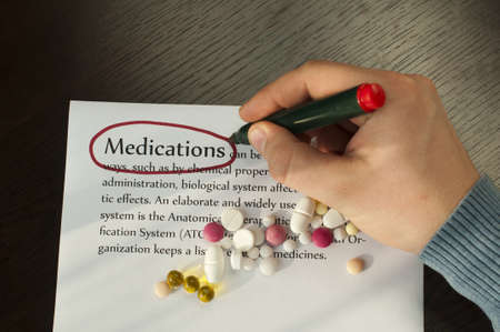 Drugs on the score sheet with text medications. Hand write on paperの写真素材