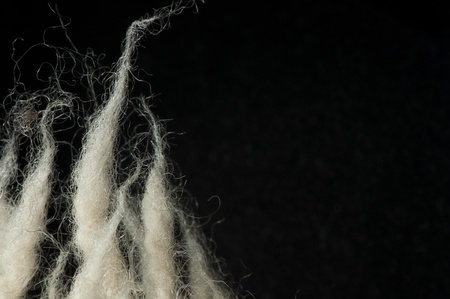 White wool fibers closeup. Black isolated
