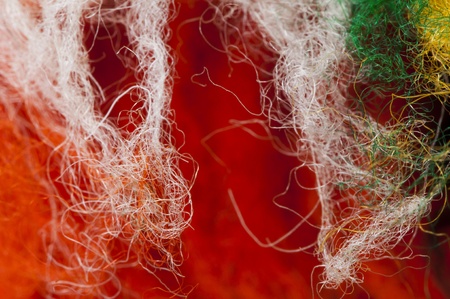 White and red wool fibers closeup
