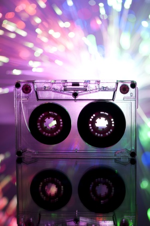 Cassette tape and multicolored pink blue lights on backgroundの写真素材