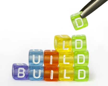 Text build on colorful wooden cubes over whiteの写真素材