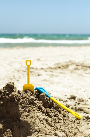 Toys in the sand on the beachの写真素材