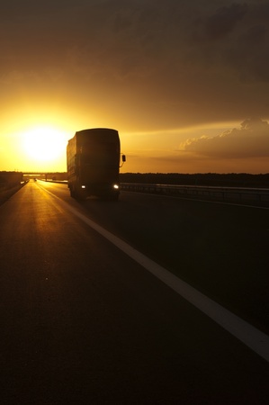 Truck traveling at sunset の写真素材