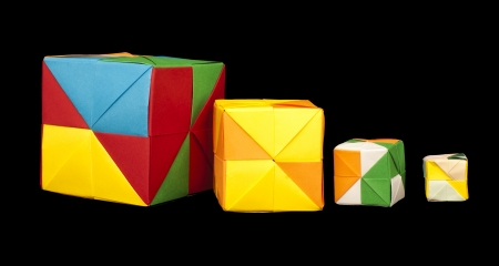 Paper made multi colored patterned cubes folded origami style.