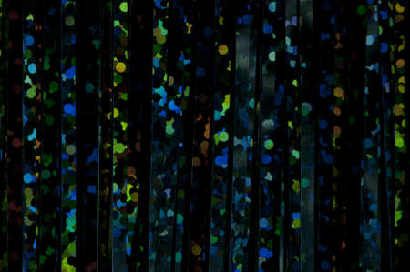 Dark background with bright multicolored shiny patternsの写真素材