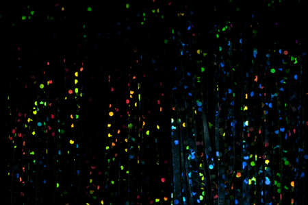 Dark background with bright multicolored shiny patterns
