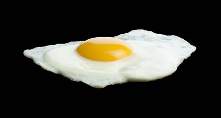 Fried egg on black background.の写真素材
