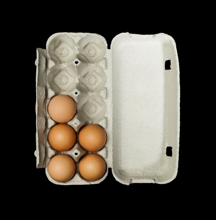 Eggs box and aggs inside. Isolated on black background.の写真素材