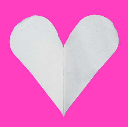White paper heart on a pink background. Divided paperの写真素材