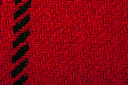 Handmade knit black and red background. Close up structure of the yarn. Christmas colorsの写真素材