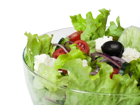 Mixed salad in a glass bowl close up. White isolatedの写真素材