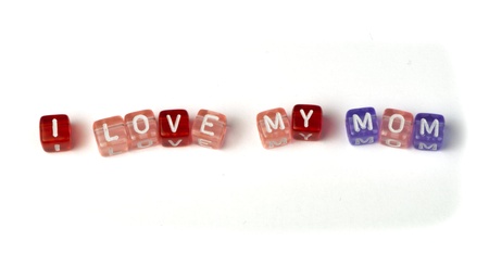 Phrase I love my mom on multicolored wooden cubes white isolatedの写真素材