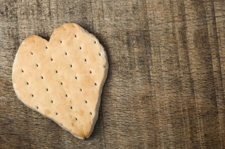 Heart shape cookie on wooden background. Copy spaceの写真素材