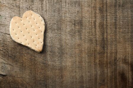 Heart shape cookie on wooden background. Copy spaceの写真素材