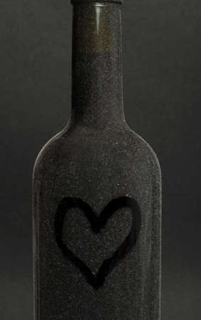 Heart painted on a red wine bottleの写真素材