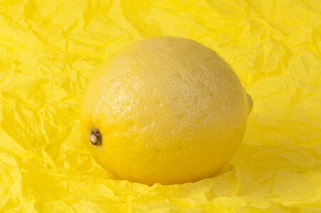 Lemon on a yellow background. Studio shot.の写真素材