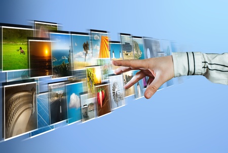 Hand reaching images streaming from the deep on blue backgroundの写真素材