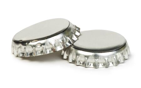 Beer caps white isolated studio shot. Close up metal capの写真素材
