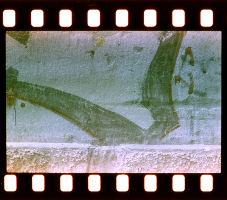 Aged street wall background, vintage graffity. Film stripの写真素材