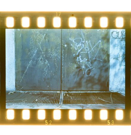 Aged street wall background and door. Film stripの写真素材