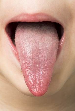 Human tongue protruding out. Child tongue.の写真素材