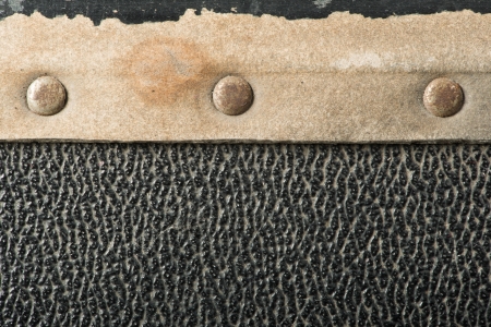 Rivets and leather parts from suitcase close up
