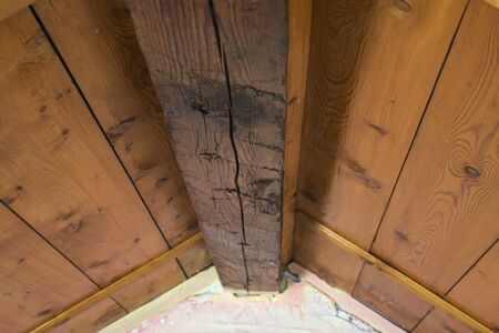Wooden ceiling and pink wall. Small room ceiling