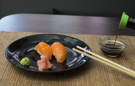 Sushi in sushi bar. Table and ration sushi with salmonの写真素材