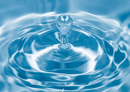 Drop in water. Blue waterdrop macro shot