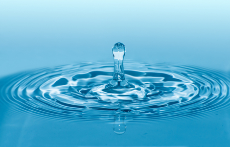 Drop in water. Blue waterdrop macro shotの写真素材