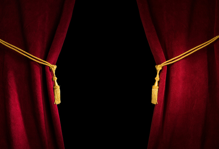 Red velvet curtain with tassel. Close up black isolated curtainの写真素材