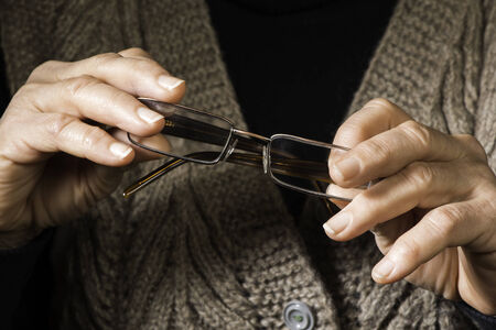 Old women hands hold glassesの写真素材