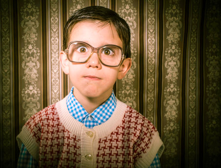 Smiling child with glasses in vintage clothes. Close up shotの写真素材