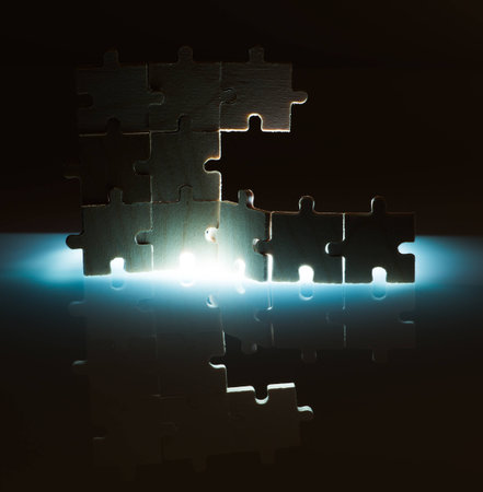 Wooden puzzle and backlight background. Vertically stacked parts.の写真素材