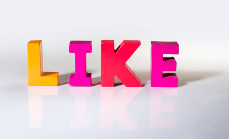 Multicolored text like made of wood. White backgroundの写真素材