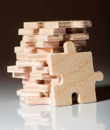 Wooden puzzle on white background. Pile of puzzleの写真素材