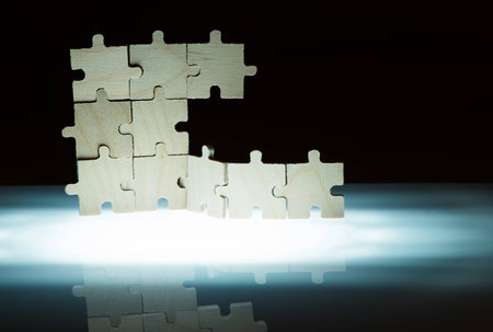 Wooden puzzle and backlight background. Vertically stacked parts.の写真素材