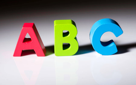 Multicolored letters A B C made of wood.の写真素材