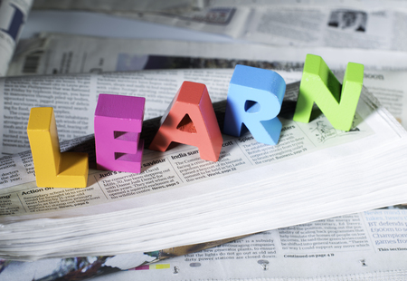 Word learn on newspaper. Wooden letters