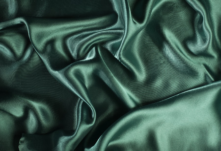 Shiny green satin pleated fabric background. Close upの写真素材