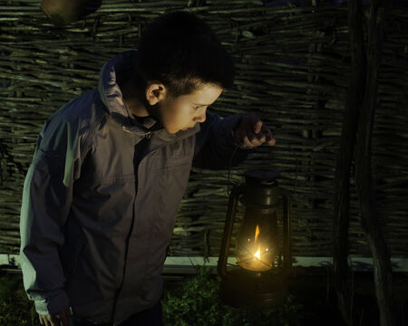 Child walk in the darkness with gas lanternの写真素材