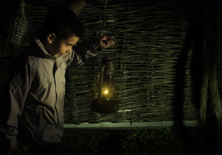 Child walk in the darkness with gas lanternの写真素材